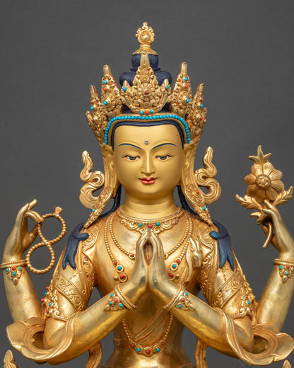Close-up of Chenrezig Bodhisattva statue showing gold-painted face and sacred objects