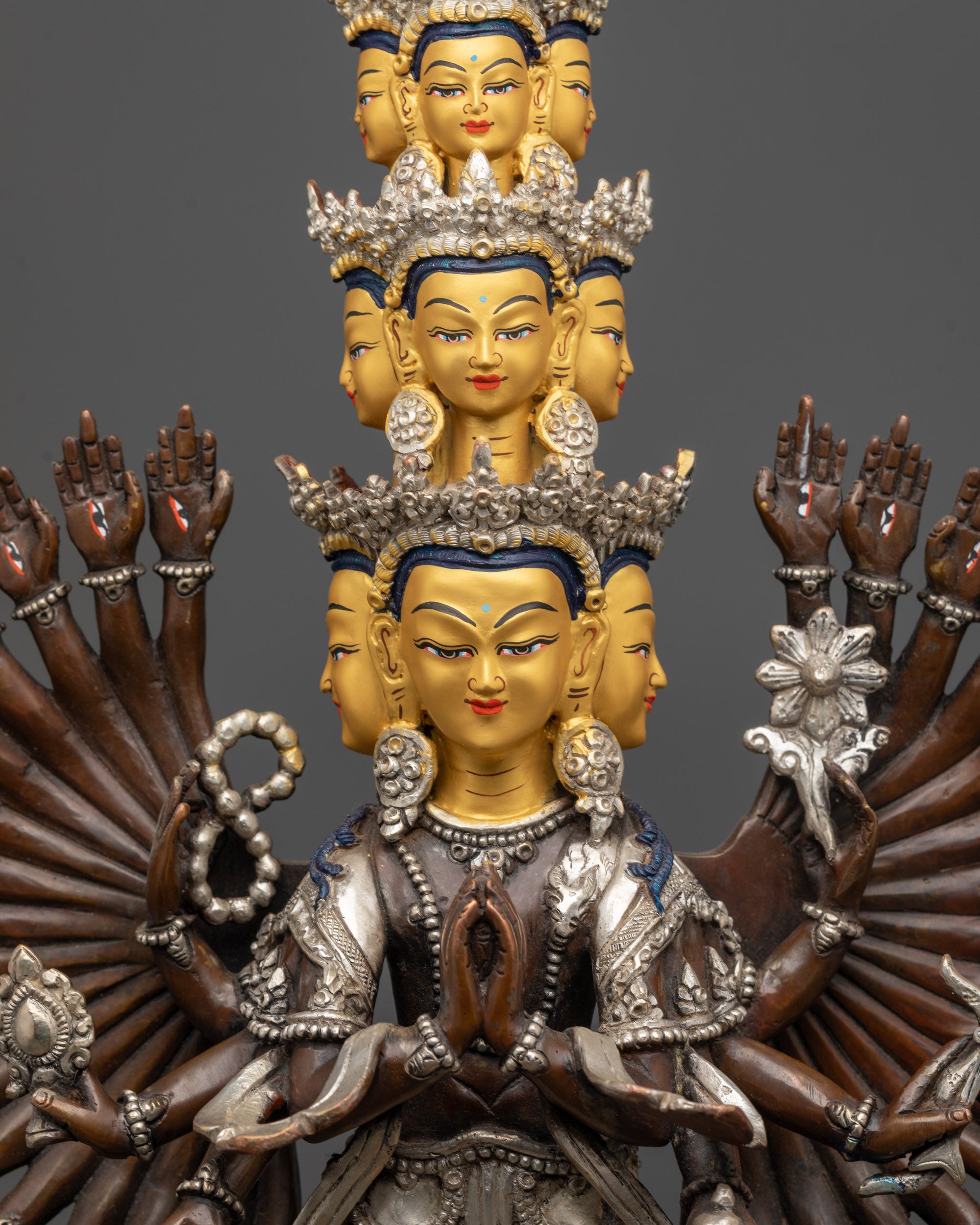 Close-up of Chenrezig Statue with eleven serene faces and crystal rosary details