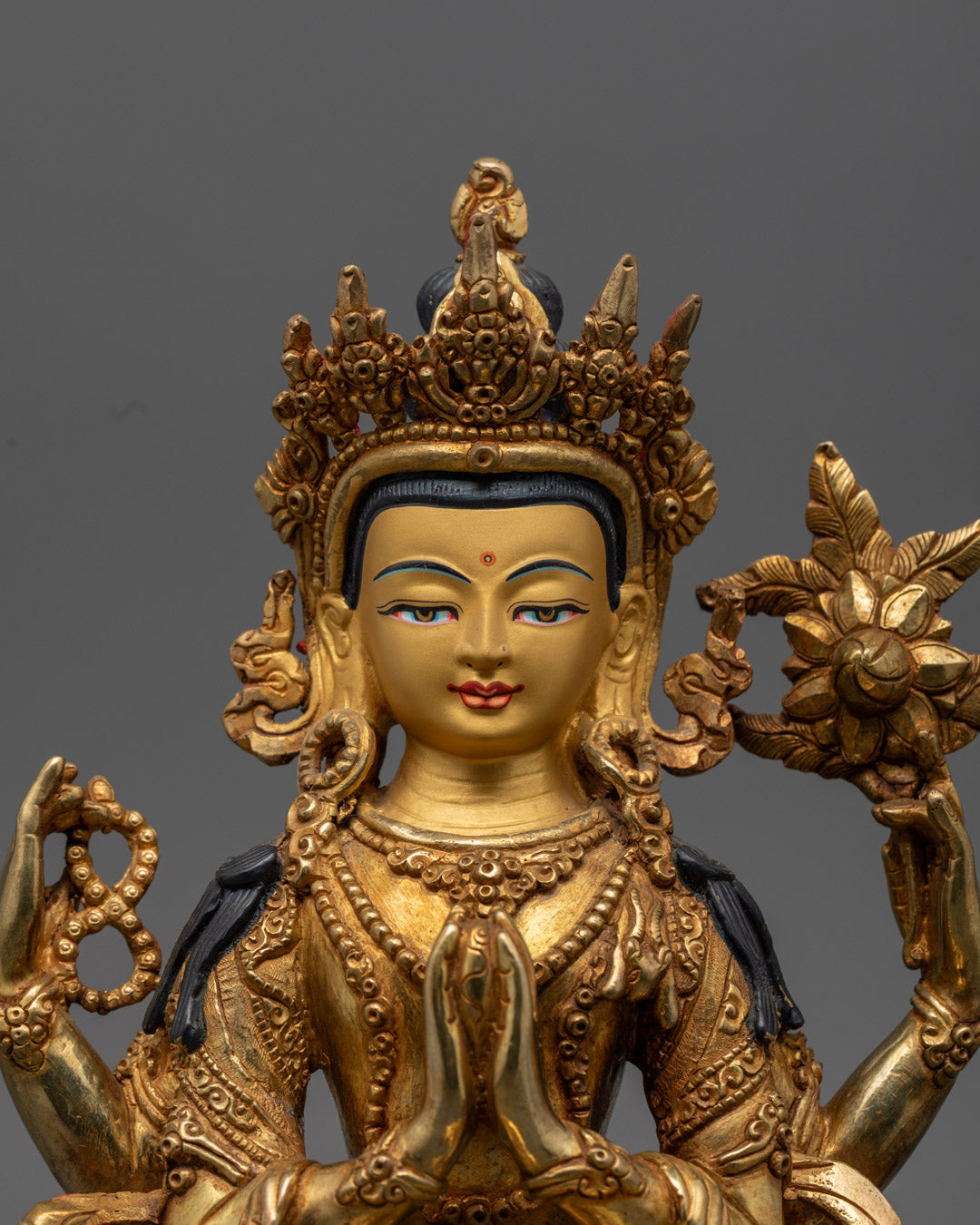 Chenrezig's serene face and intricate crown, fire-gilded with pure 24k gold, showcasing expert Nepalese craftsmanship