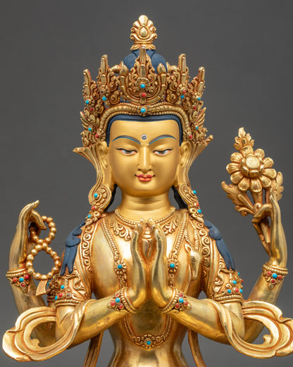 Close-up of Chenrezig statue face showing serene expression and 24K gold detailing