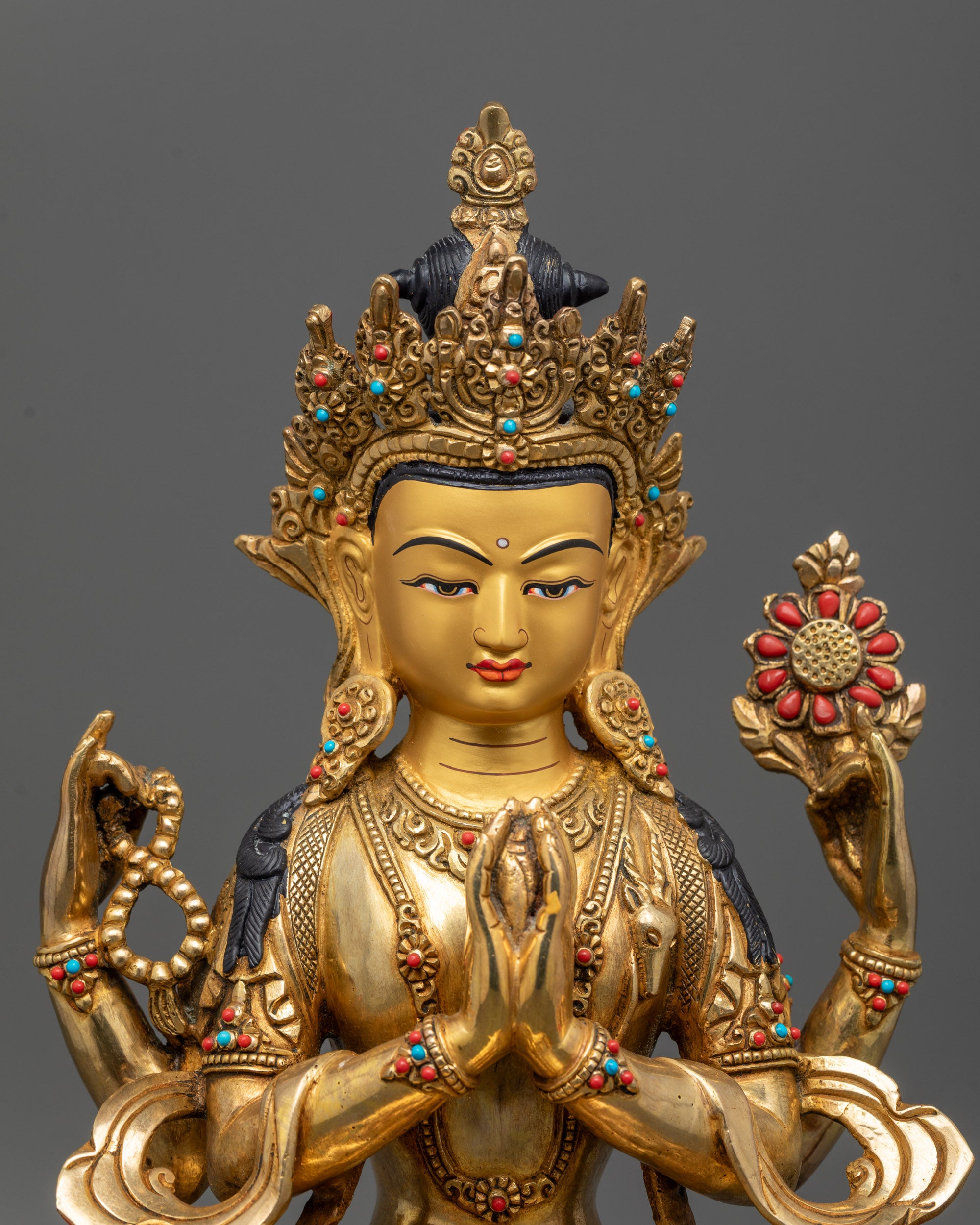 Close-up of Chenrezig statue showing intricate details, symbolic objects