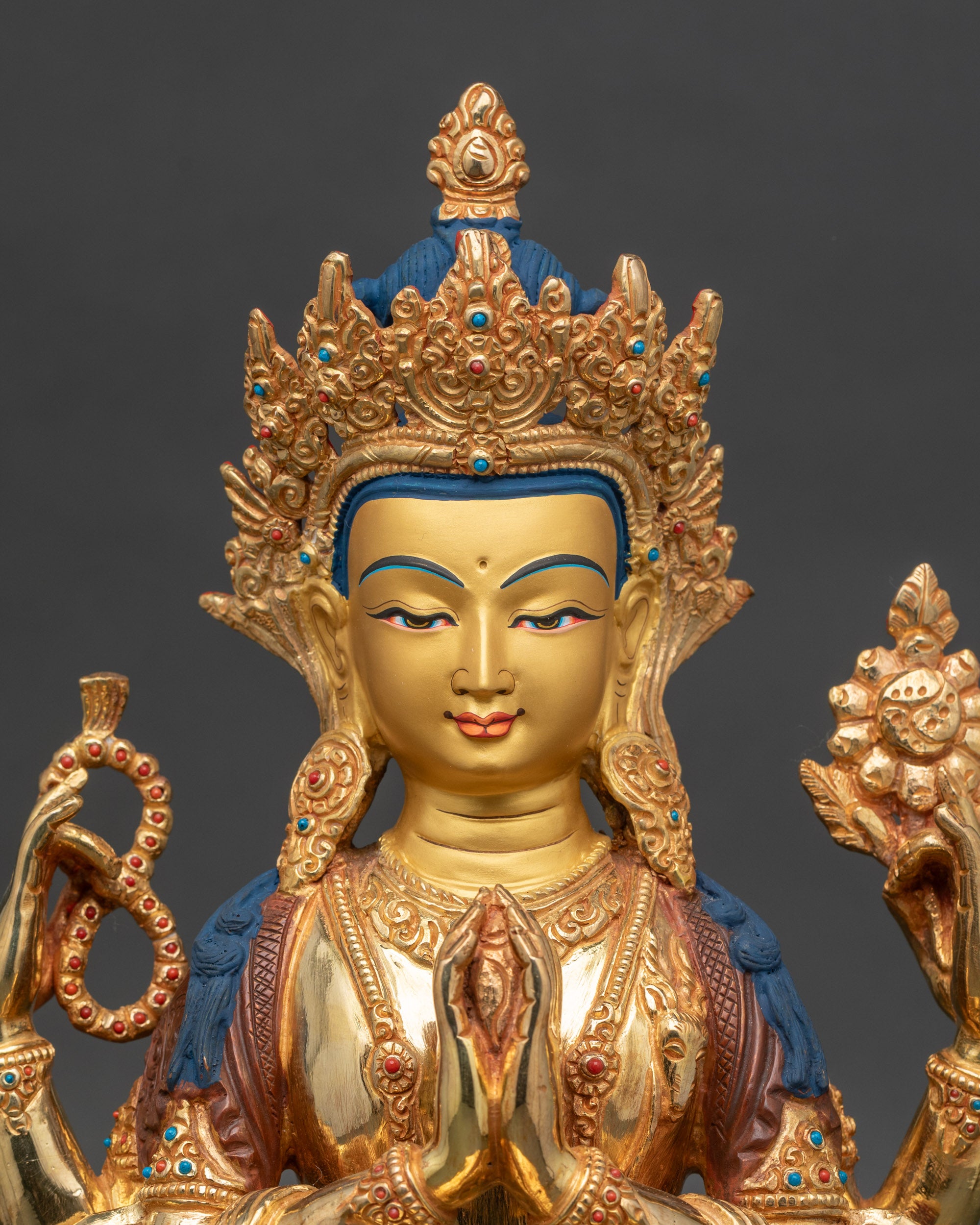 Close-up of Chenrezig statue showing wish-fulfilling jewel and 24K gold-painted accents