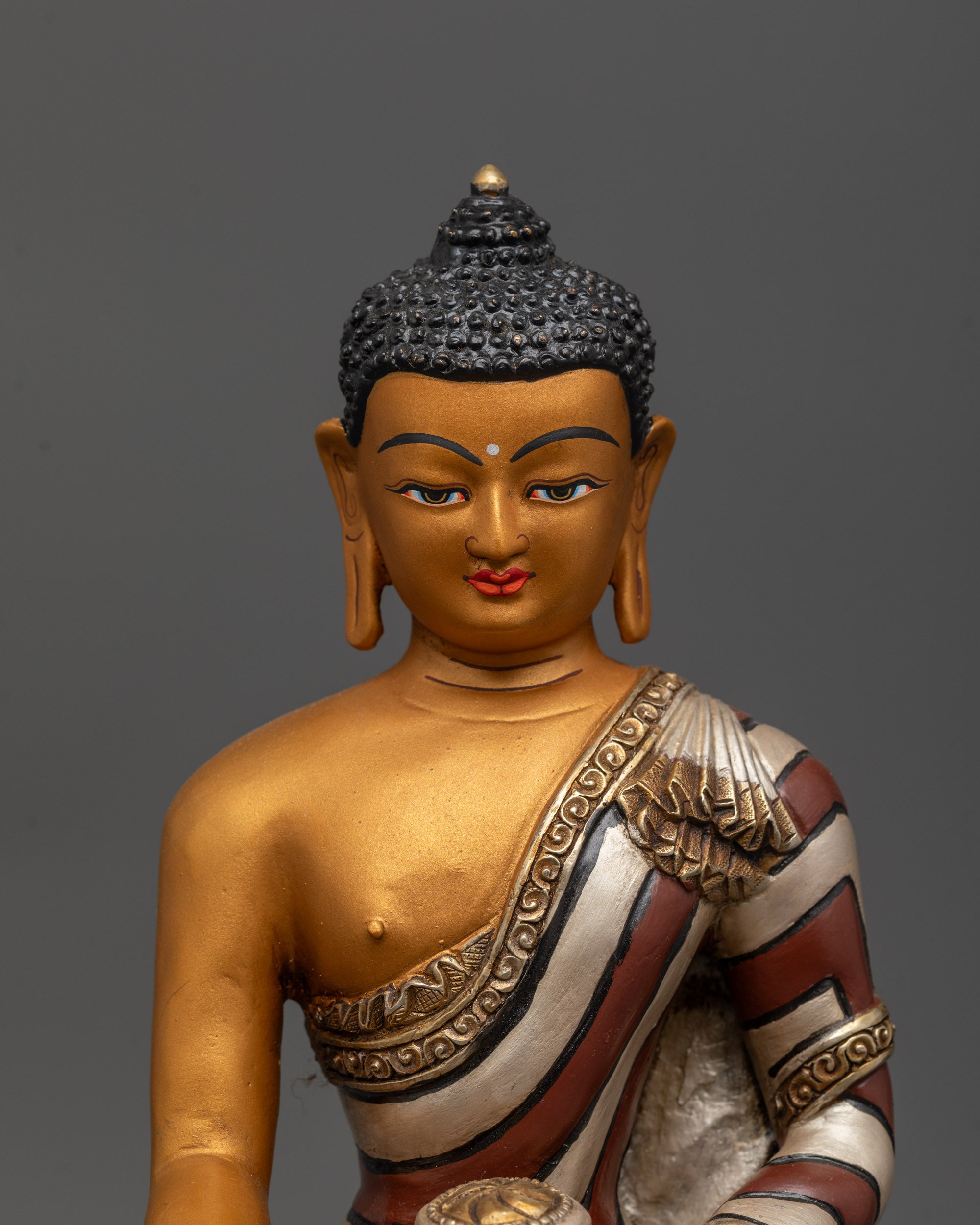 Close-up of Copper-based Shakyamuni Buddha sculpture with intricate detailing