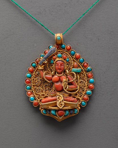 Close-up of Coral Manjushri pendant showing lapis sword, turquoise Prajna Paramita, fine detail