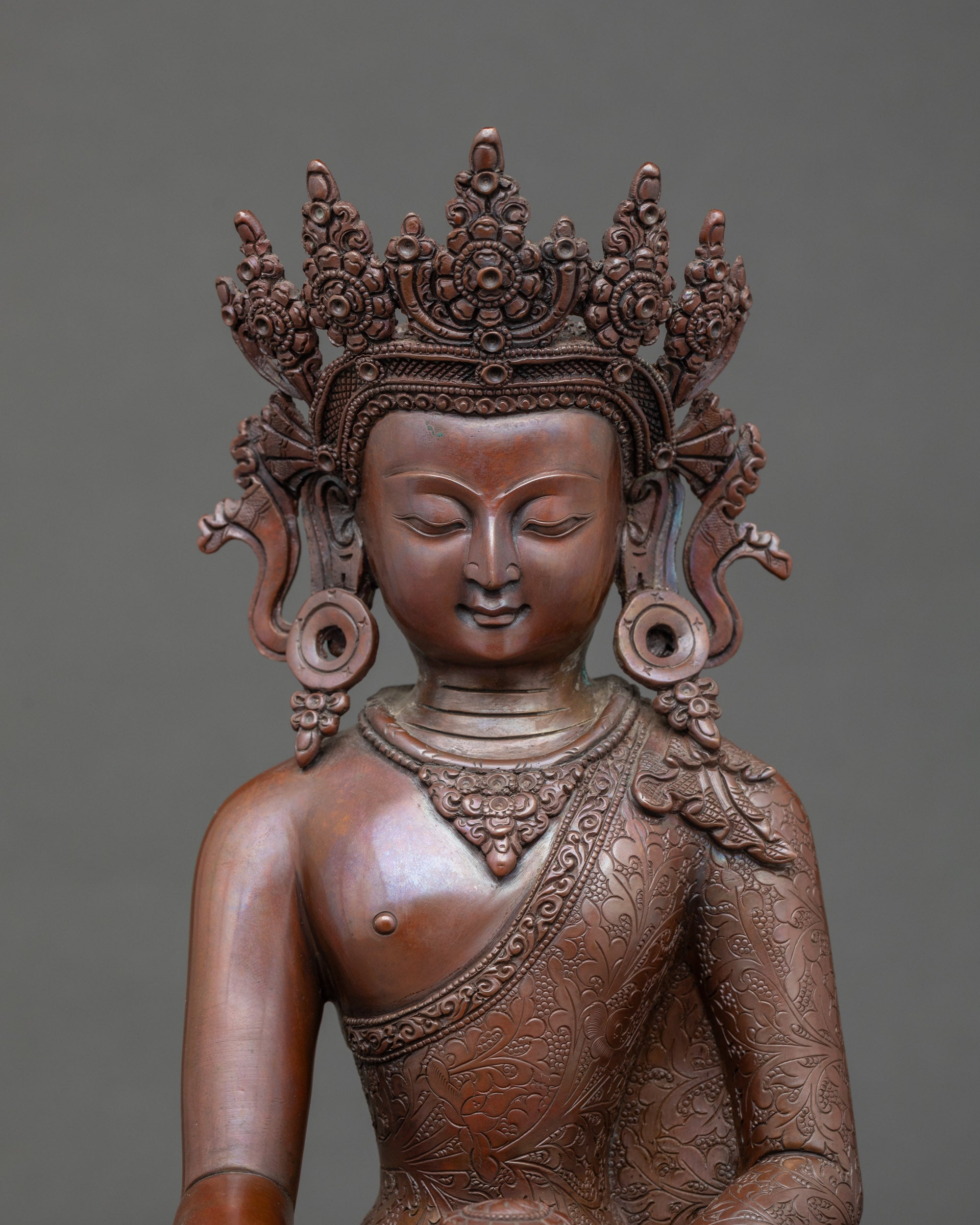 Close-up of Crown Buddha Icon showing serene face and monk’s bowl details