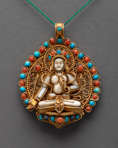 Close-up of Crystal White Tara locket showcasing detailed gold-gilded filigree and semi-precious stones – Tibetan healing and protection talisman.