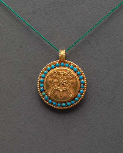 Close-up of Dharma Wheel Locket showing detailed carving and gemstone inlay
