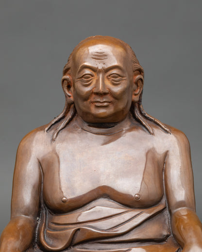 Close-up of Dilgo Khyentse Rinpoche figurine showing serene face and intricate robes