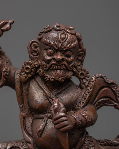 Close-up of Dorje Drolo’s radiant halo and intricate carvings on oxidized copper statue