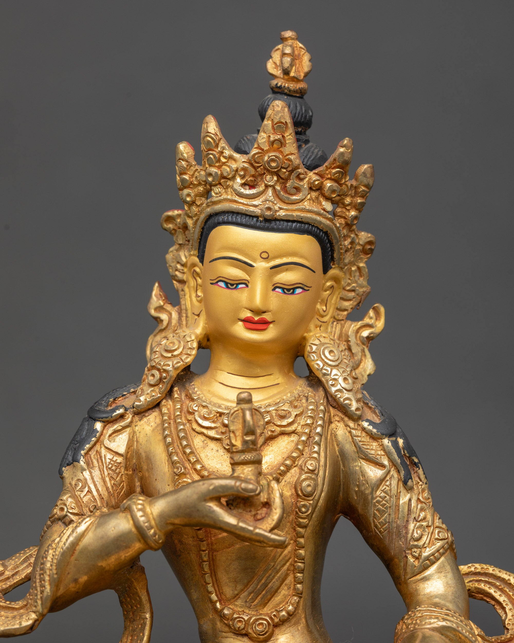 Close-up of Dorje Sempa Buddha showing intricate gold gilding and painted details