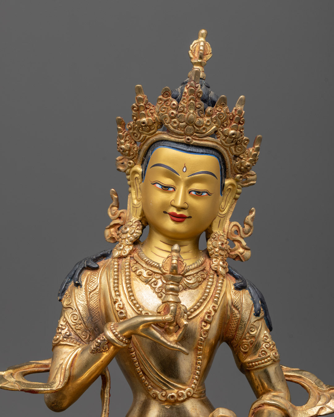 Close-up of Dorje Sempa holding vajra and bell, showcasing intricate gold detailing