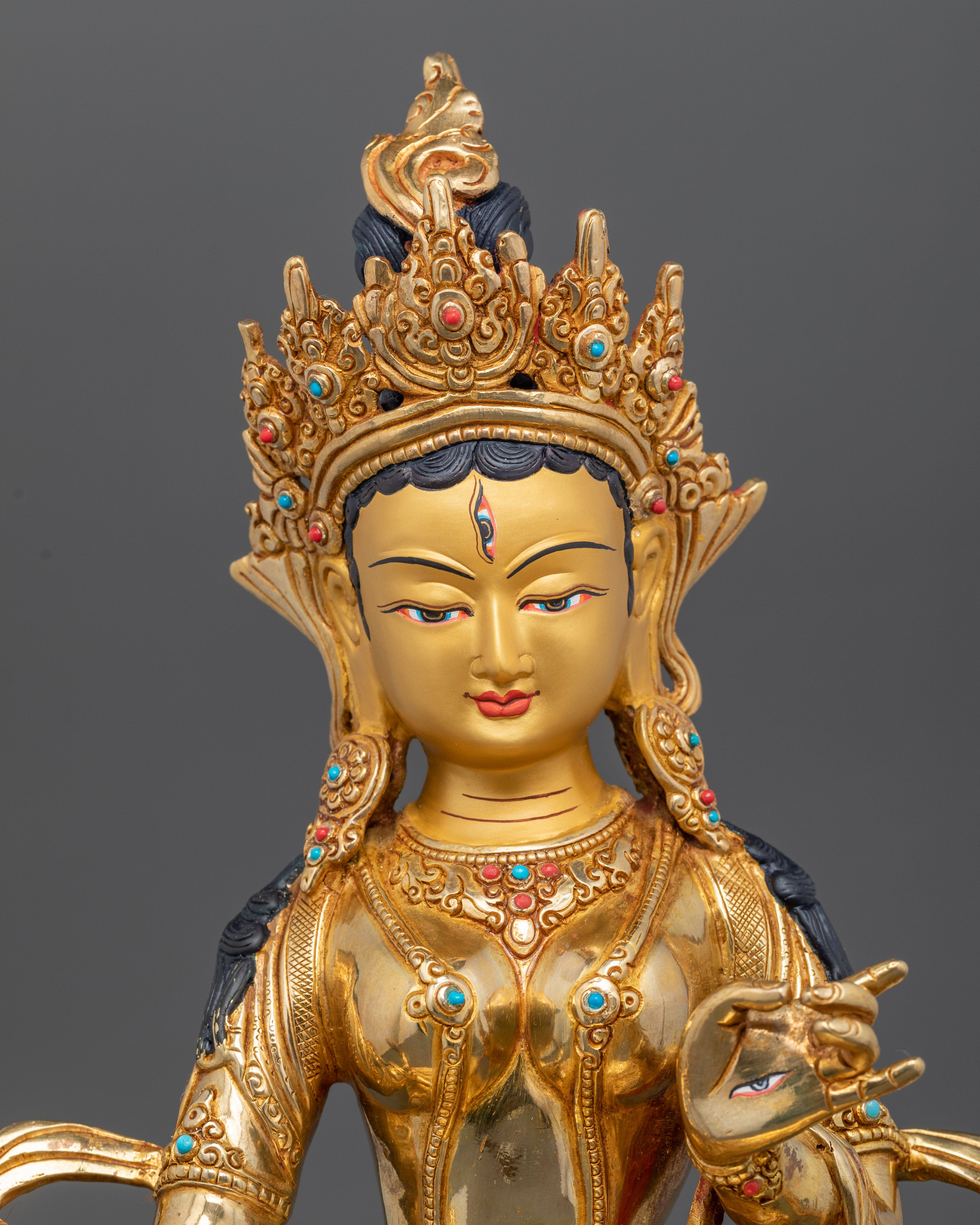 Close-up of Dukar statue showing intricate gold fire-gilding and carved parasol details