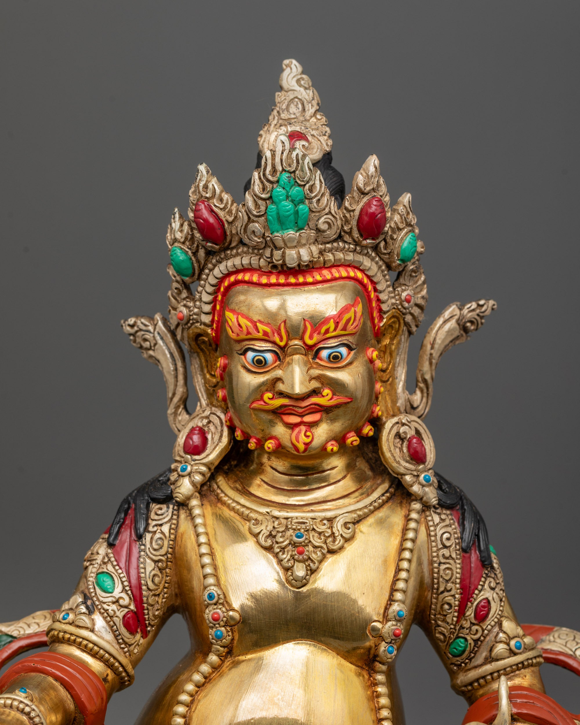 Close-up of Dzambhala Statue showing intricate five-jeweled crown and semi-precious jewelry