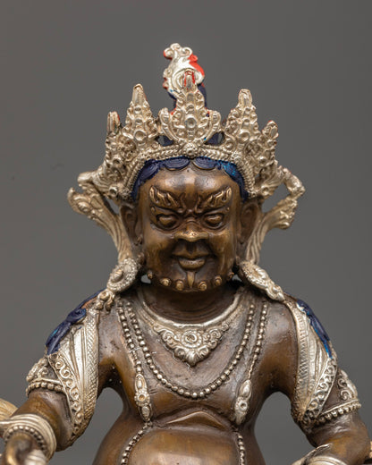 Dzambhala’s jewel-spouting mongoose and intricate carvings, representing the removal of poverty and blessings of fortune.