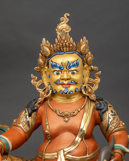 Close-up of Dzambhala statue showing halo and stone inlay details