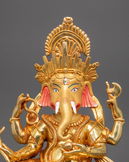 Close-up of Ganesh Ji’s crown and jewelry, highlighting detailed gold fire-gilded body
