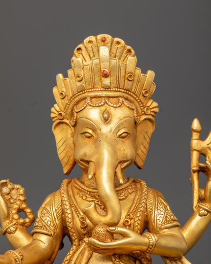 Ganesh’s intricately detailed elephant head, showcasing premium gold gilding and hand-painted red accents.
