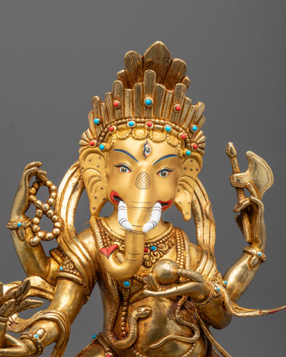 Close-up of Ganesh’s serene face and detailed hands carrying traditional Hindu symbols