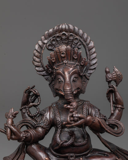 Close-up of Ganesha's oxidized copper face showing intricate electroplated detailing

