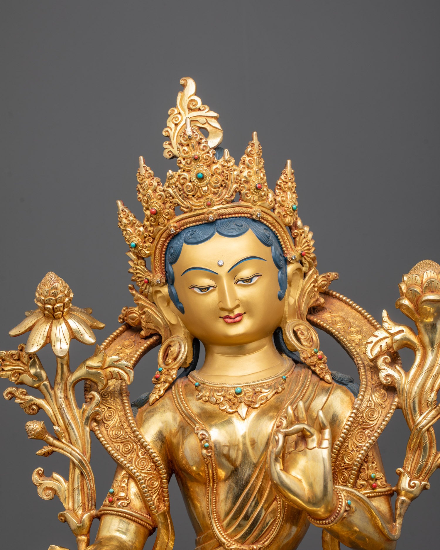 Close-up of Goddess Green Tara’s gold-gilded face and 5-jeweled crown

