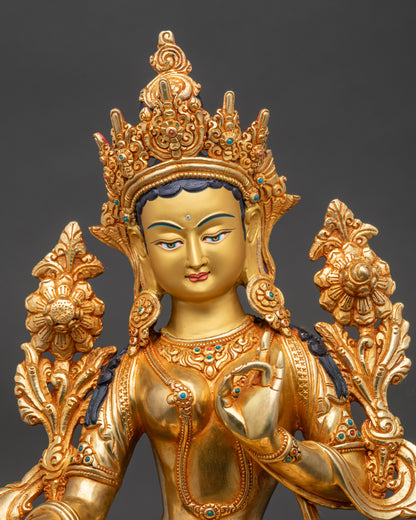 Close-up of Green Tara Bodhisattva face, radiant gold-painted features and serene expression