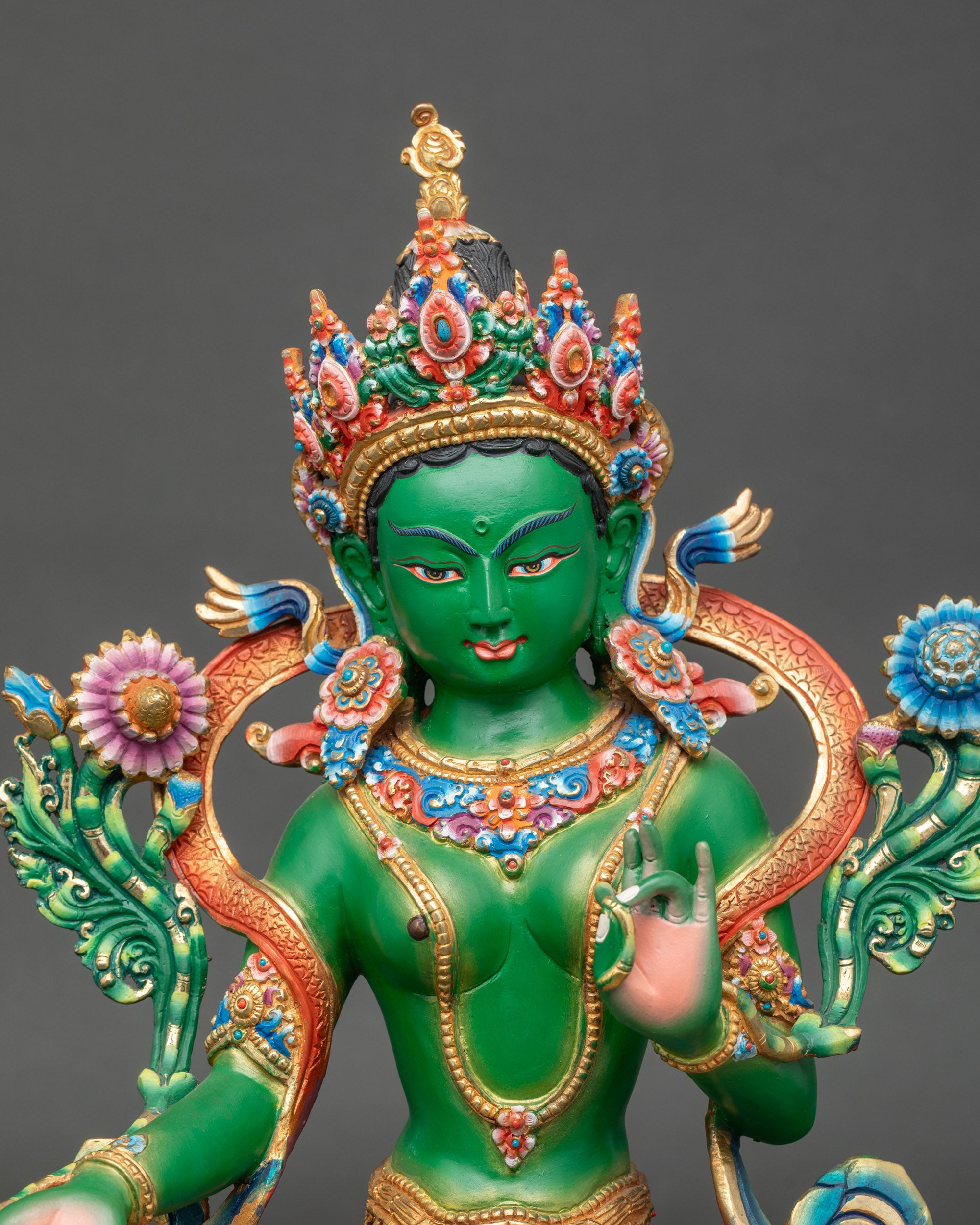 Close-up of Green Tara Bodhisattva sculpture showing intricate details and five-jeweled crown
