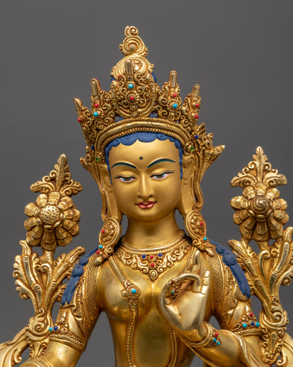 Gold-colored statue with intricate details on a dark background