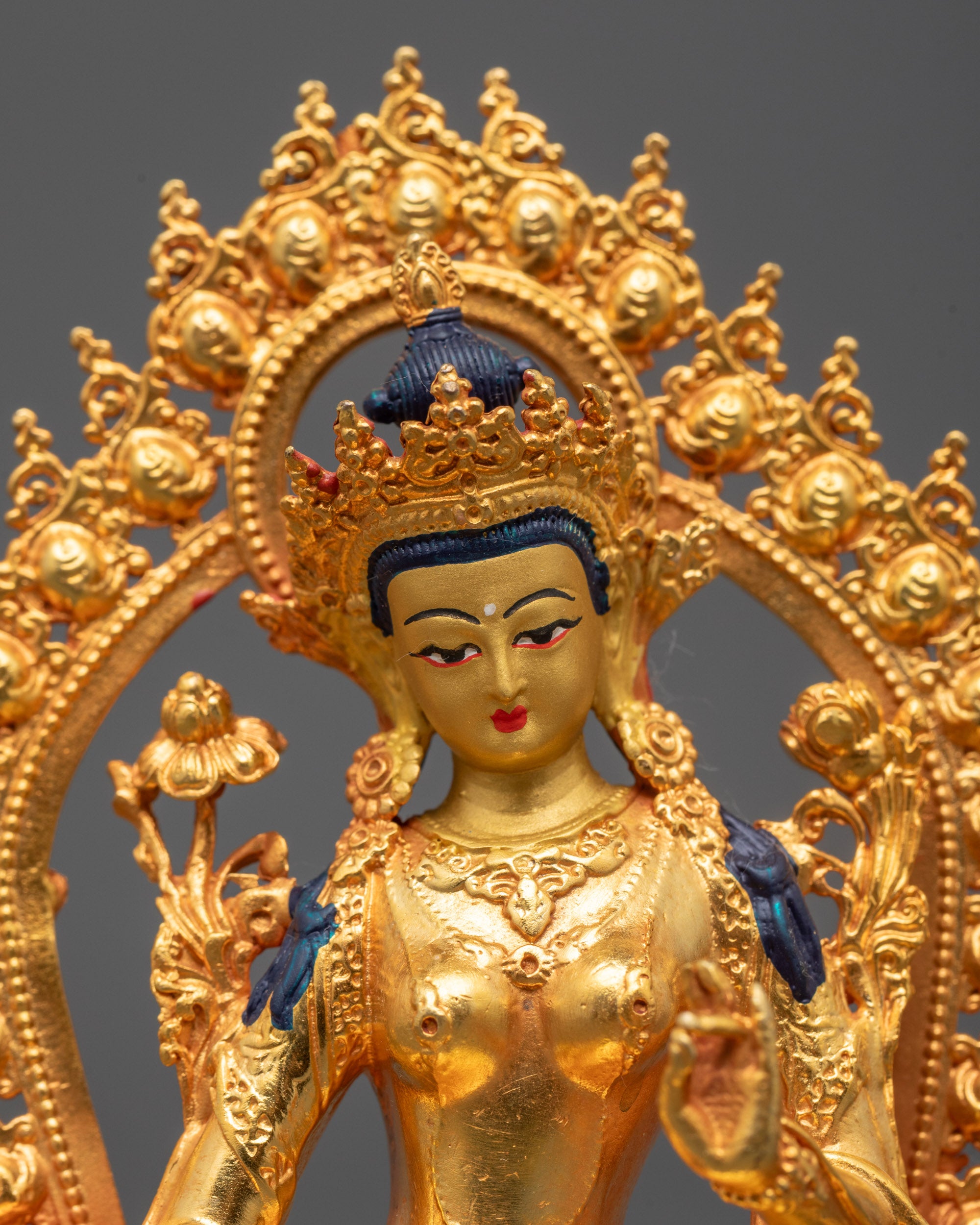 Close-up of Green Tara Buddha statue featuring radiant 24k gold finish and hollow chamber
