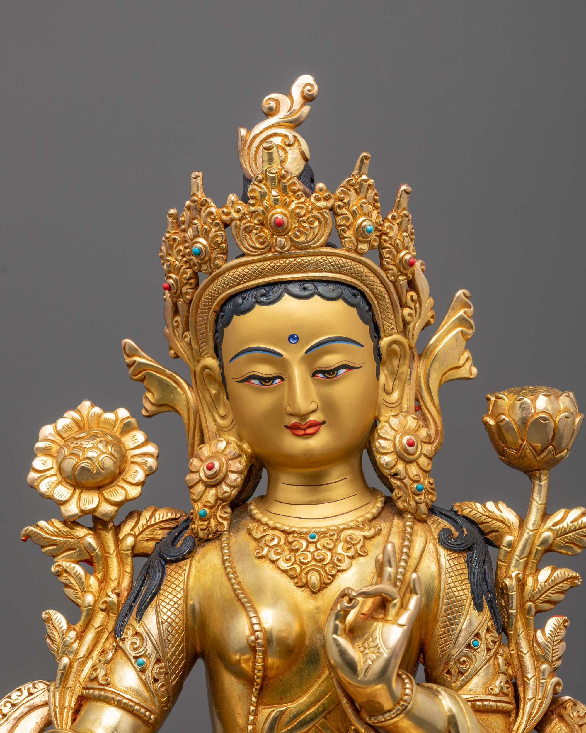 Close-up of Green Tara Statue’s serene face and meditative varada mudra posture