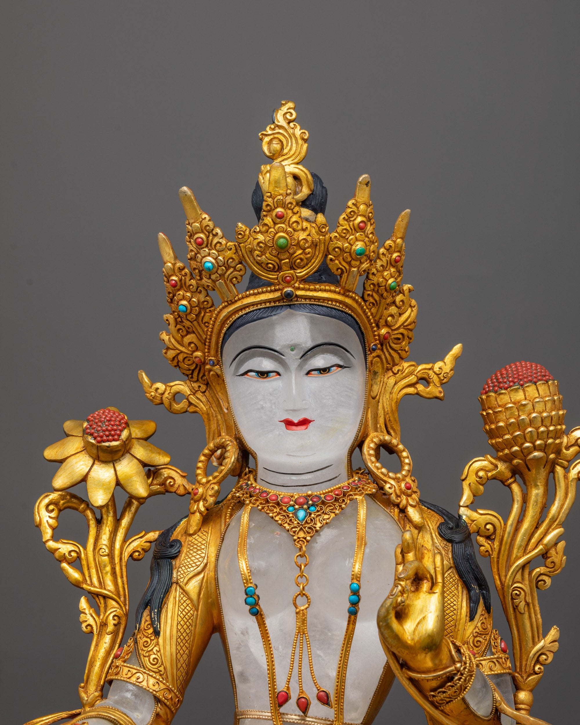 Close-up of Green Tara face, crown, and coral-inlaid utpala flower with 24K gold detail