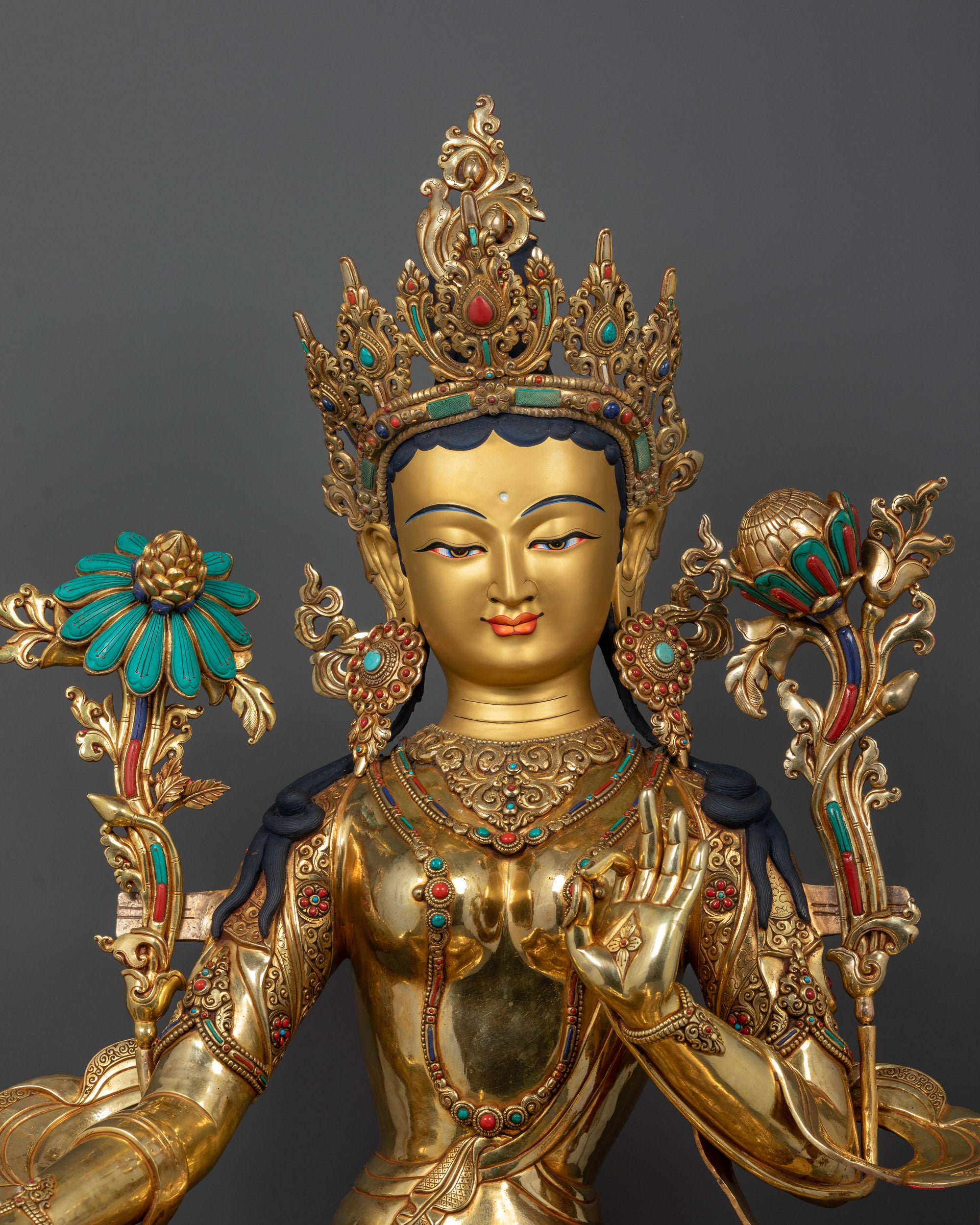 Close-up of Green Tara face with 24k gold-plated detailing and intricate stone inlays