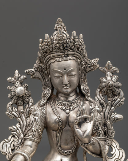 Close-up of Green Tara face with intricate silver-plated detailing