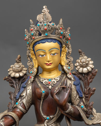 Close-up of Green Tara face with serene expression and gold detailing
