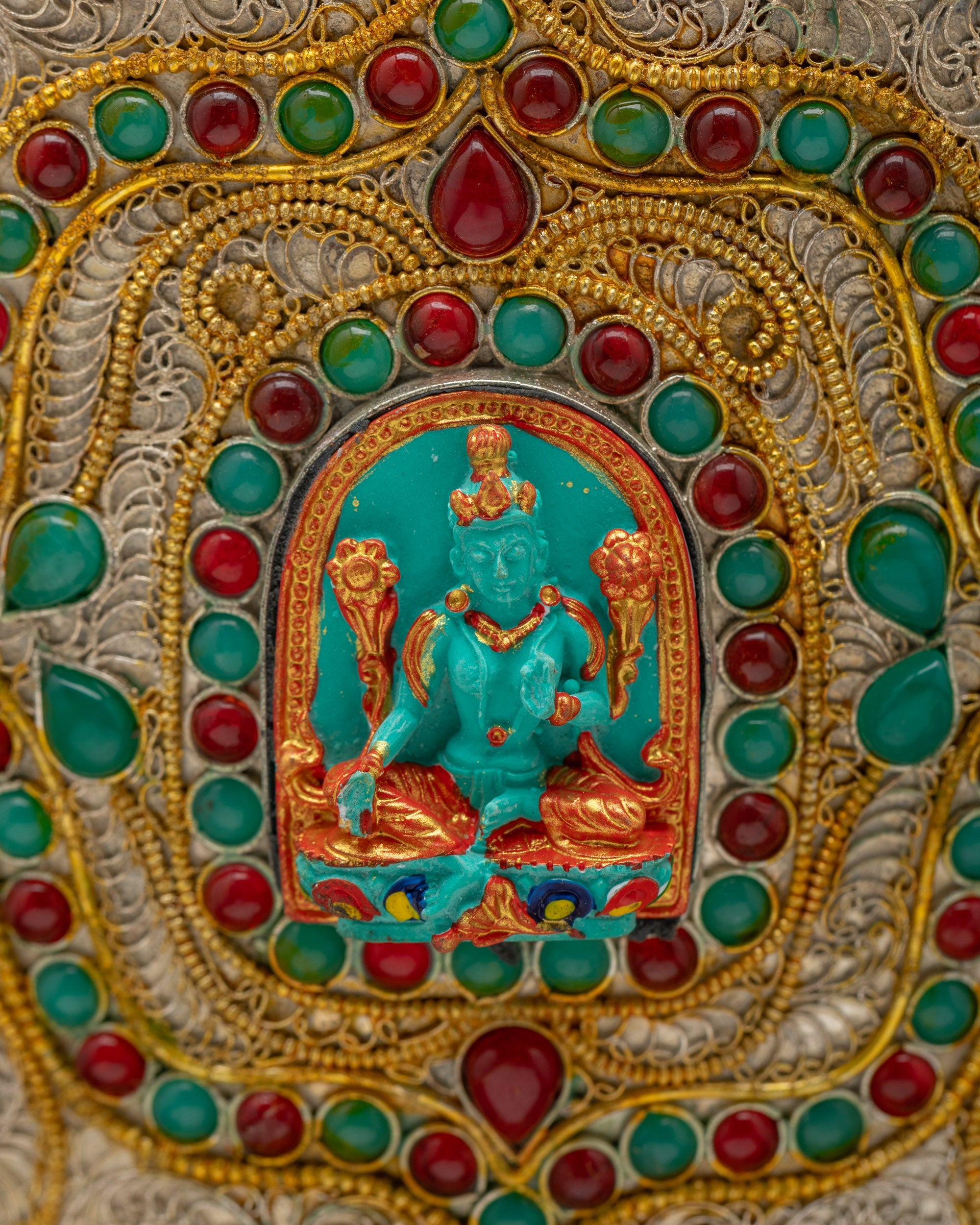 Close-up of Green Tara figurine and auspicious symbols on Nepalese Himalayan Vase radiating blessings, purity, and sacred energy.