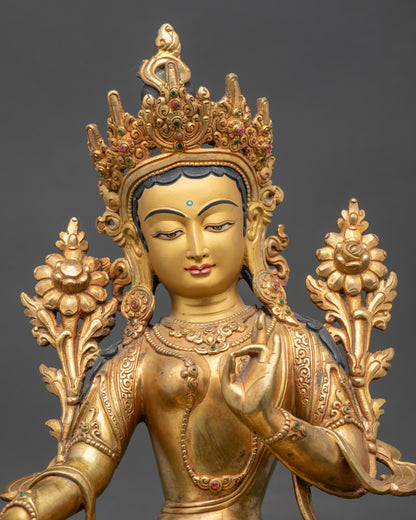 Close-up of Green Tara goddess face, gold fire-gilded copper, Newari craftsmanship detail
