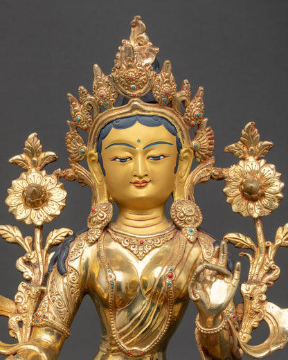 Close-up of Green Tara gold-painted face and detailed Himalayan craftsmanship carvings