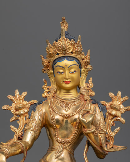 Close-up of Green Tara’s blue utpala flower and detailed 24K gold-gilded face