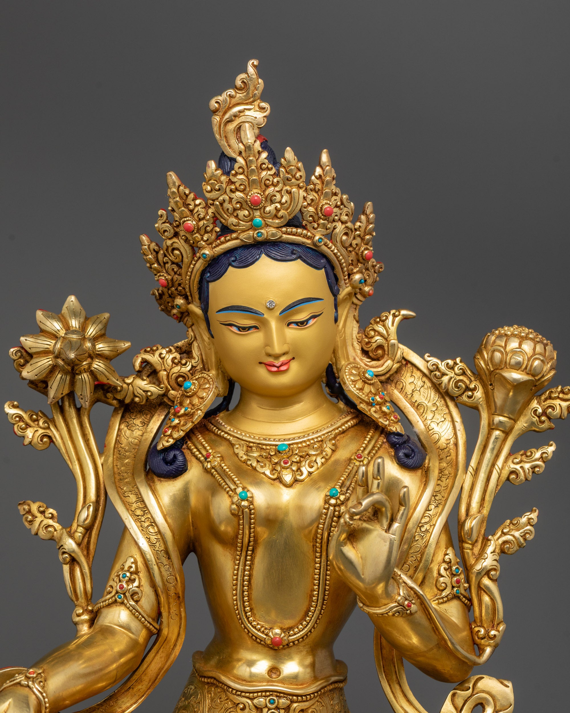 Close-up of Green Tara's five-jewel crown and 24k gold-gilded face