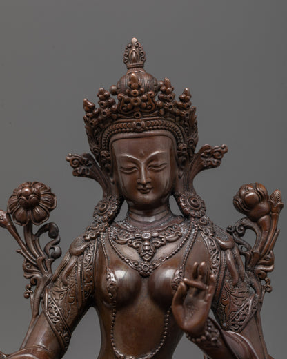 Close-up of Green Tara’s peaceful face and right hand in varada mudra symbolizing compassion
