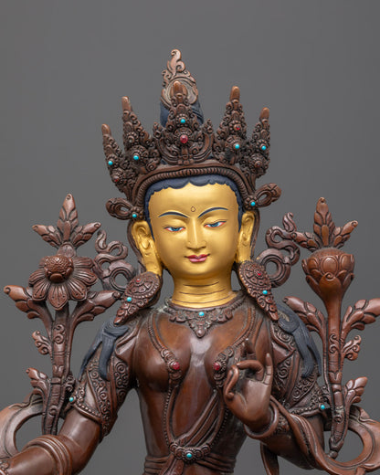 Close-up of Green Tara's serene expression with gold detailing