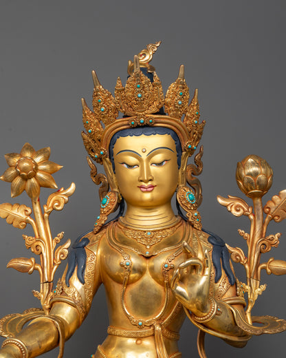 Close-up of Green Tara’s serene face adorned with gold and acrylic detailing