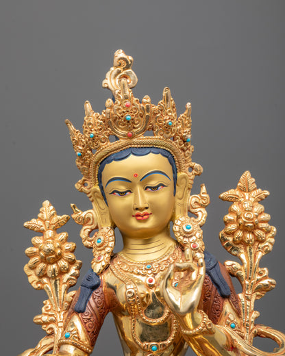 Close-up of Green Tara’s serene face and detailed semi-precious stone adornments