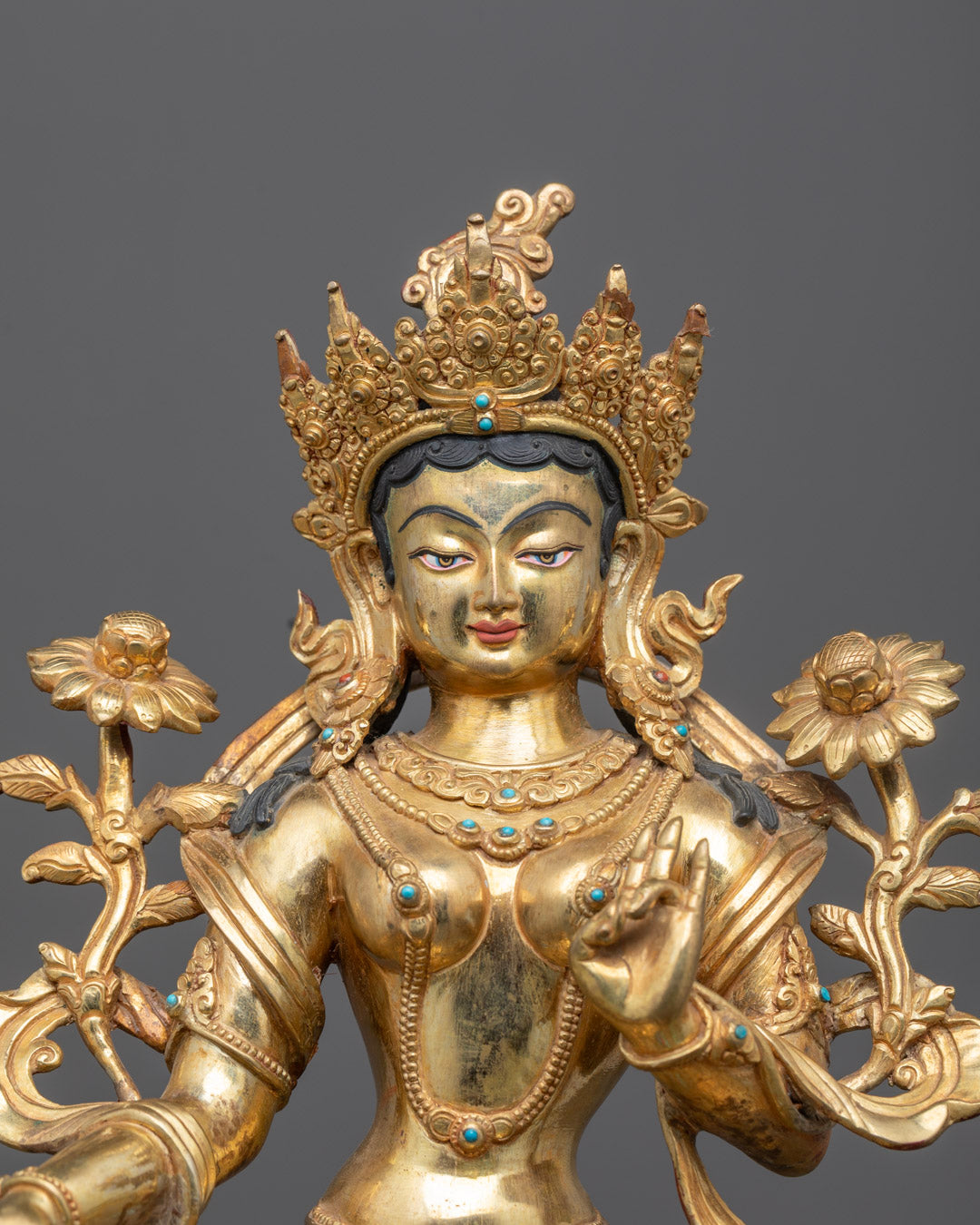 Close-up of Green Tara’s serene face gilded with 24k gold handcrafted in Nepal