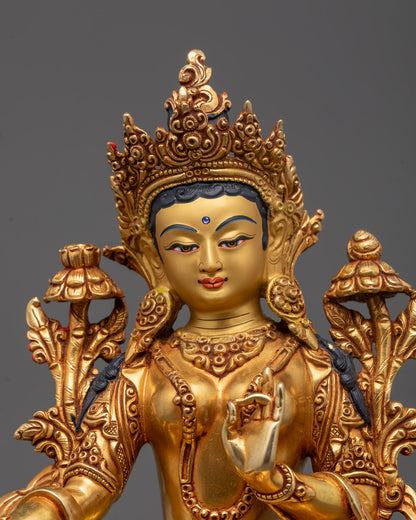 Close-up of Green Tara’s utpala flower, crown, and detailed facial expression