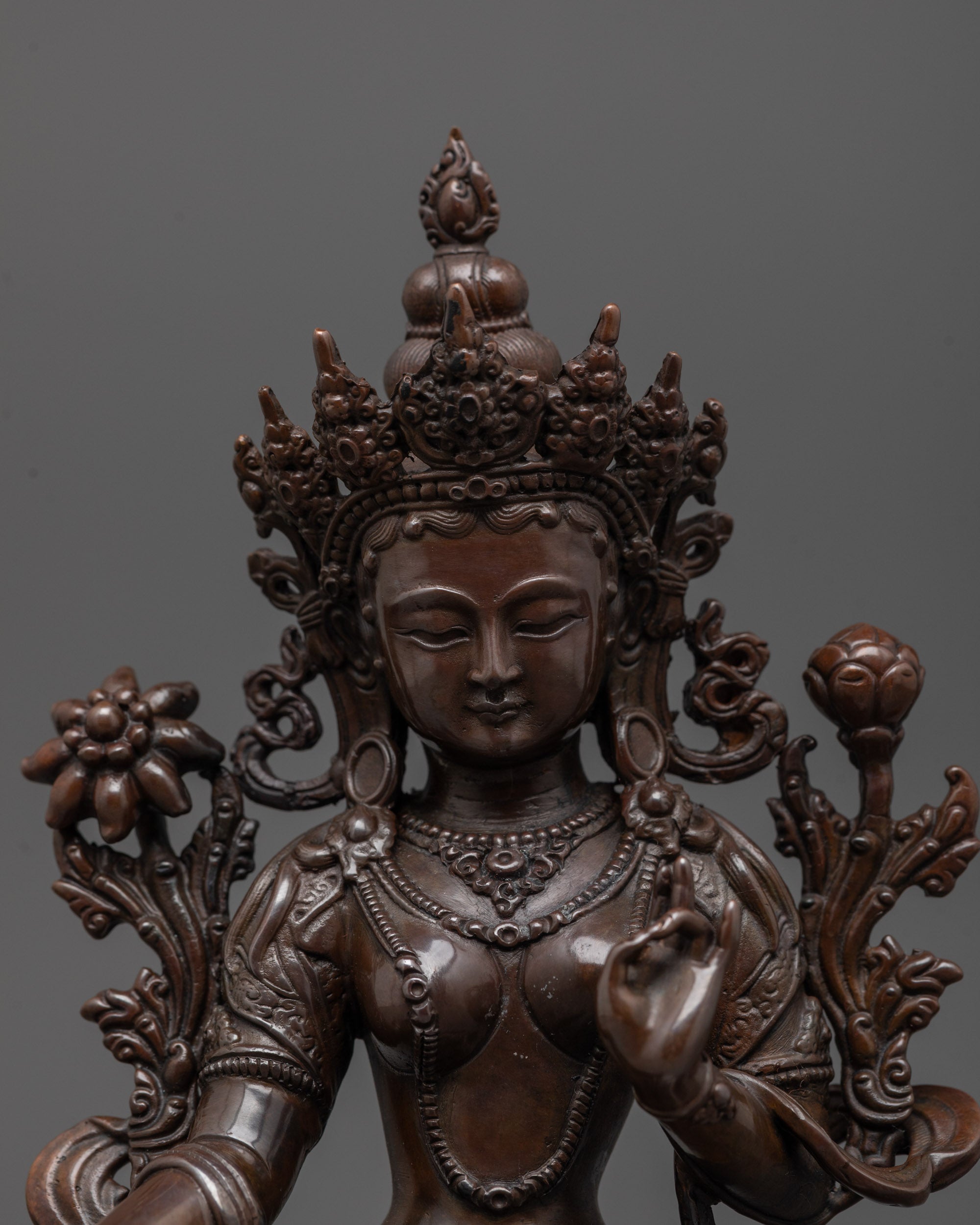 Close-up of Green Tara statue’s oxidized copper face showing detailed electroplated finish