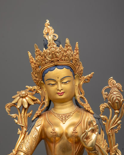 Close-up of Green Tara statue’s serene expression with gold-plated face