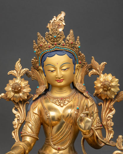 Close-up of Green Tara statue’s serene gold-painted face and five-jeweled crown