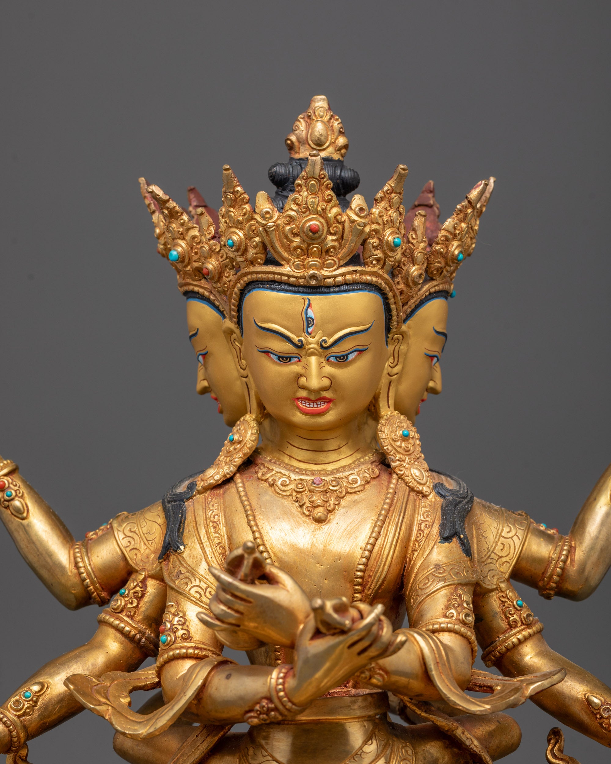 Close-up of Guhyasamaja Statue’s gold-gilded face and multiple arms