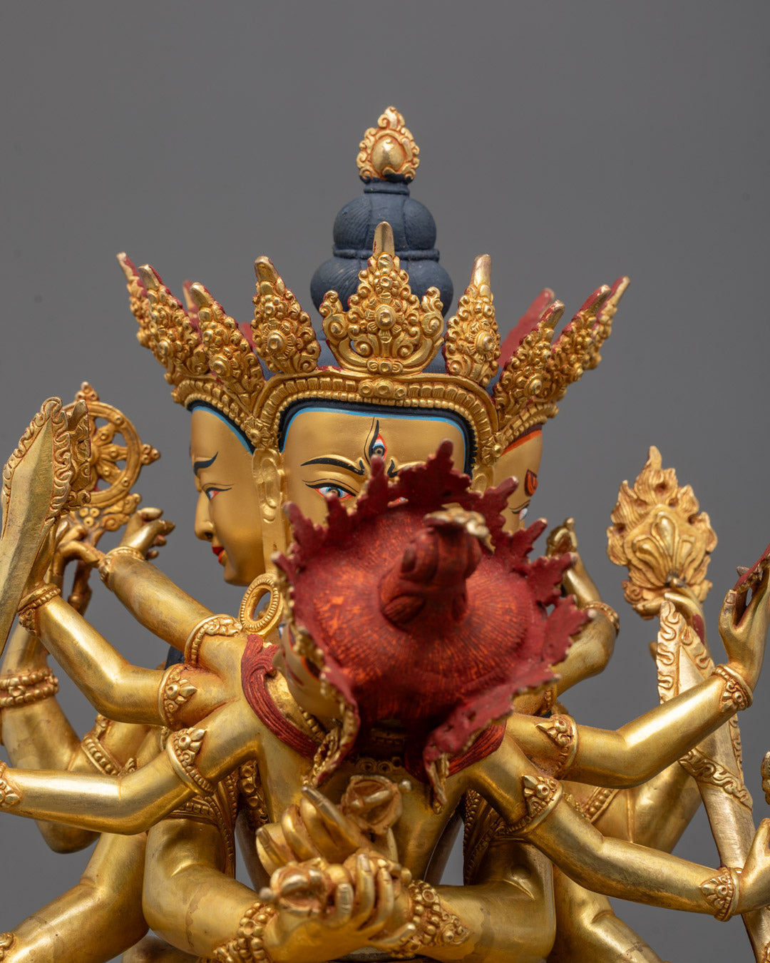Close-up of Guhyasamaja deity's serene face with ornate crown and third eye
