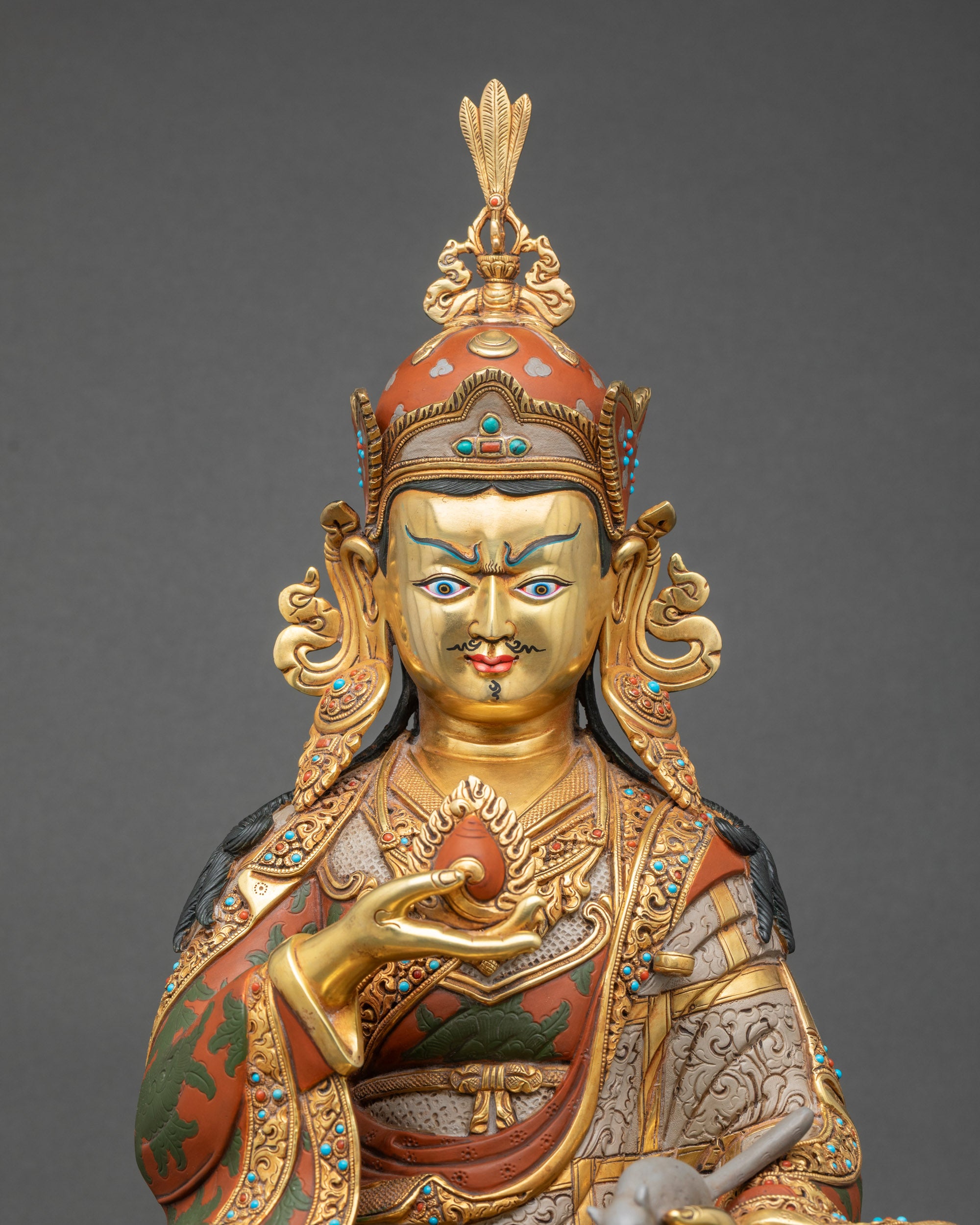 Close-up of Guru Norlha statue with intricate gold gilding and hand-painted details